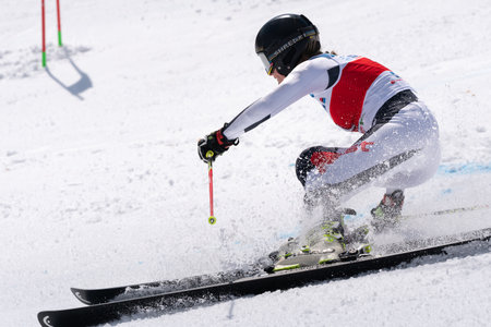 KAMCHATKA PENINSULA, RUSSIAN FEDERATION - APRIL 1, 2019: Mountain skier Golenkova Valentina Moscow Region skiing down snowy mountain slope. Russian Women's Alpine Skiing Championship, giant slalom.のeditorial素材