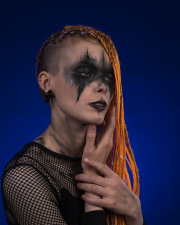 Cinematic portrait of beautiful young woman with orange color dreadlocks hairstyle and horror black...