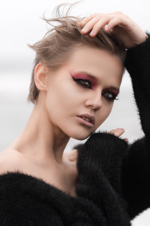 Portrait gorgeous blonde woman is epitome of sensuality. She is wearing short hairdo and bright...