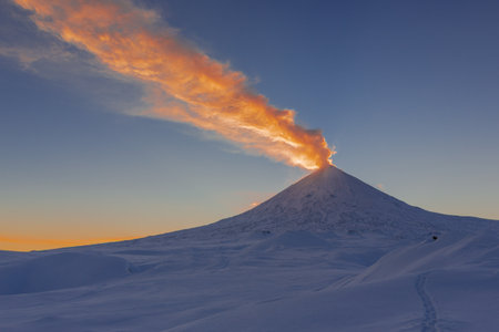 At summit of volcanos explosive eruption, ash column rose up to many km upward, extending ash...