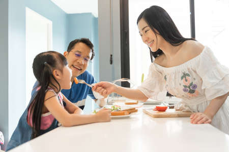 asian family having a happy meal. Happy lifestyle family moments.の写真素材
