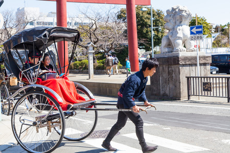 Kamakura,Japan - March 23 , 2014   Japanese Rickshaw Unidentified man running with his rickshaw  That is traditional Japanese Commercial Land Vehicle のeditorial素材
