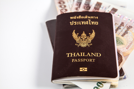 Thailand passport with Thai money ready to travel isolated on white backgroundの写真素材