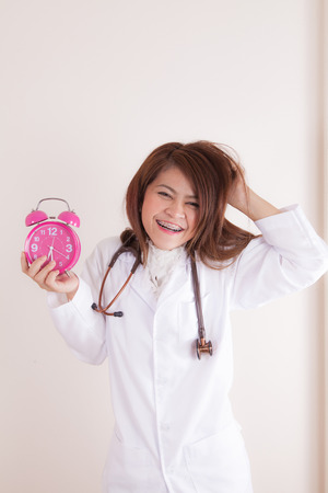 Young Female doctor wake up because calling about patient at morningの写真素材