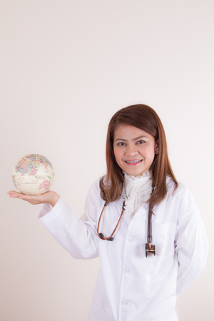 Asian Young  Female doctor showing globe on her handの写真素材