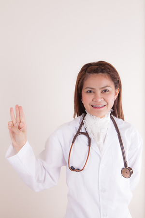 Medicine doctor woman pointing three gesture, half length closeupの写真素材