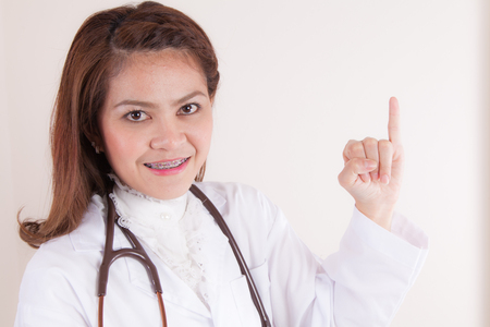 Young asian Doctor Holding up the little fingerの写真素材
