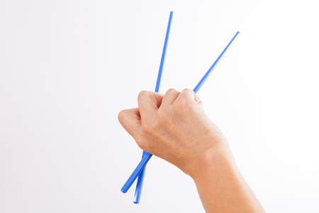 Female Hand Holding colorful Chopsticksの写真素材