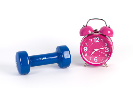 Old Vintage Pink alarm-clock and dumbbells isolated on whiteの写真素材