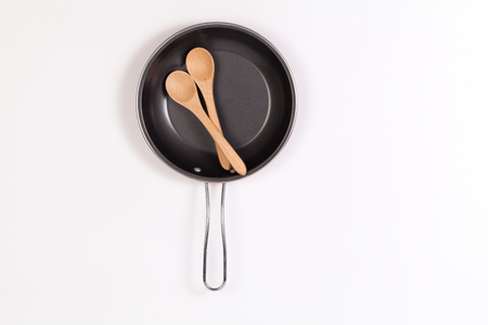 frying pan and spatula or Wooden spoon on white backgroundの写真素材