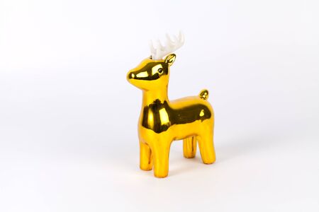 Shiny gold reindeer ornament with copy space, on white.の写真素材