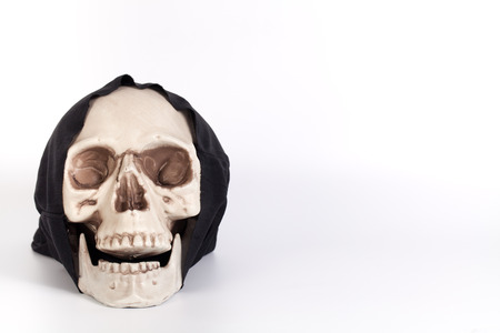 Human Skull with devil black cap isolated on whiteの写真素材
