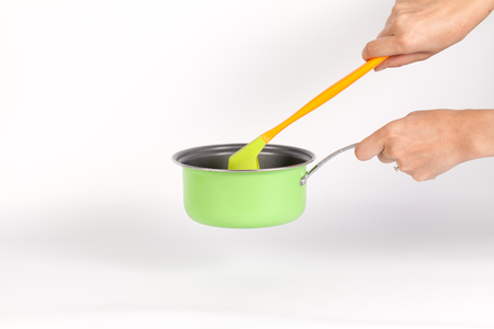 colorful utensils kitchen set : A stainless Colorful ladle with pot or pan isolated on a whiteの写真素材