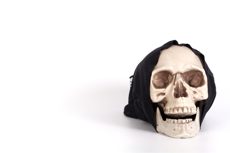 Human Skull with devil black cap isolated on whiteの写真素材