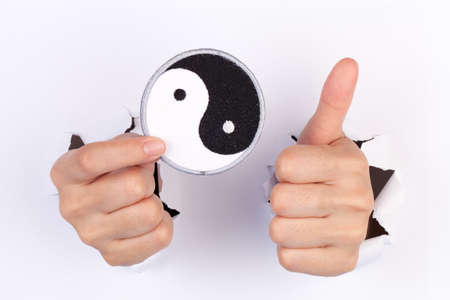 Women Hand Holding Yin and Yang Flag isolated on whiteの写真素材