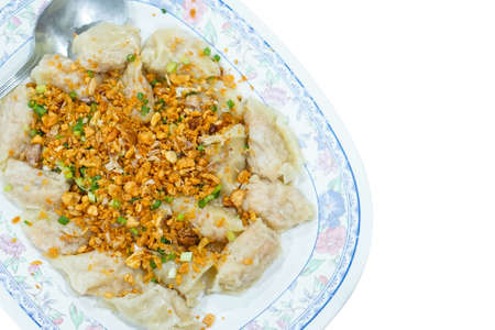 Steamed shrimp dumplings with fried sliced garlic, isolated on white background with copy space and clipping path.の写真素材