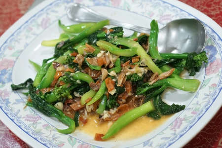Stir fried chinese Kale with salted fish and dried squid. (With selective focus)の写真素材