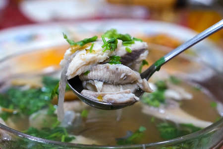 Teochew style food, boiled pomfret fish with sour plum soup. (With selective focus)の写真素材