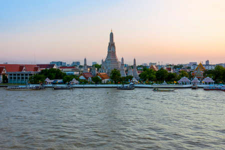 Wonderful ancient Pagoda of Wat Arun one of the most beautiful archaeological site view from Chao Phraya River side in twilight time from Bangkok, Thailand. (With warm sunlight effect)のeditorial素材