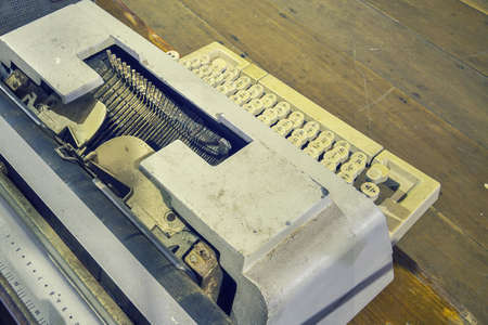 Old thai font typewriter and blur wooden background, With created vintage style photography and copy space.の写真素材