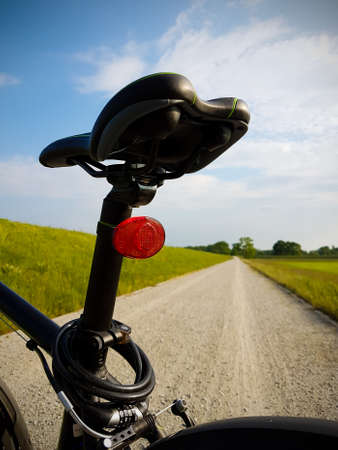 Bicycle saddle in the seat. Road in backgroundの写真素材