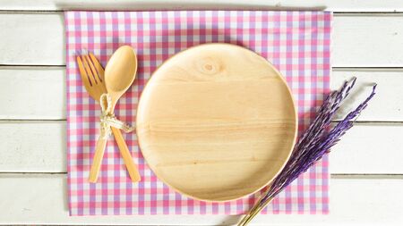 empty wooden plate with spoon and forkの写真素材