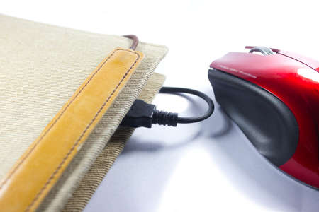 Computer mouse and book on white background and shadowの写真素材