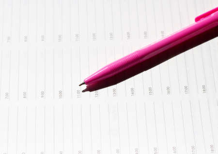 pink pen on notebookの写真素材