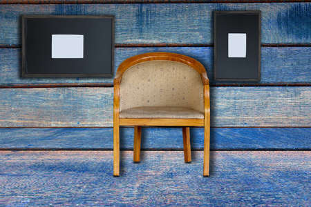 a chair and old frame on old wood backgroundの写真素材