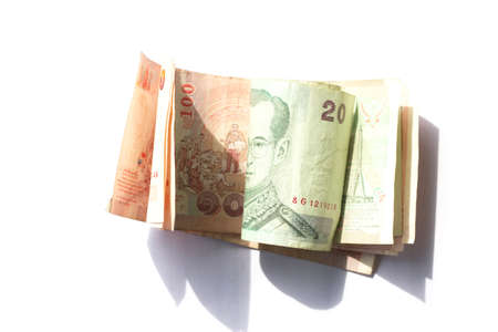100 and 20 baht thai banknote roll on white backgroundの写真素材