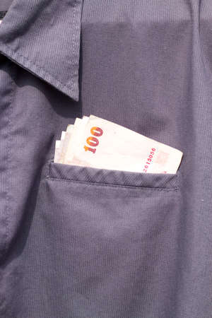 100 baht Thai money in pocket