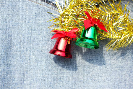 green and red bell for christmas on jean backgroundの写真素材