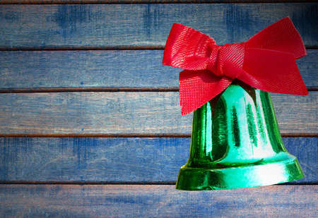 green bell on wood background