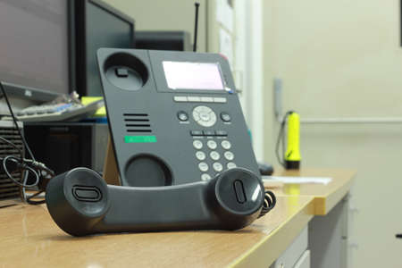 A black telephone on a wooden tableの写真素材