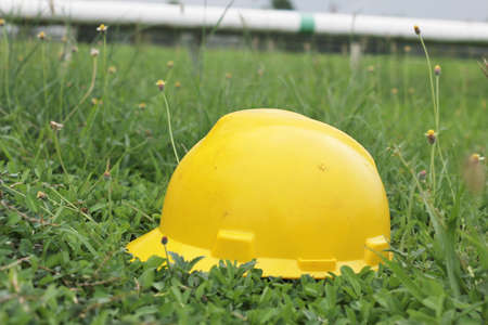 Yellow hard hat on hand wheel valveの写真素材