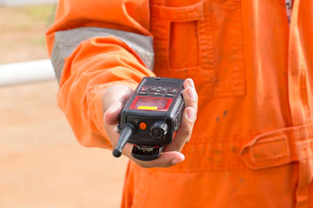 Hand and walkie talkie for outdoor tank oil backgroundの写真素材