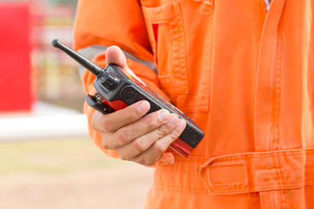 Hand and walkie talkie for outdoor tank oil backgroundの写真素材