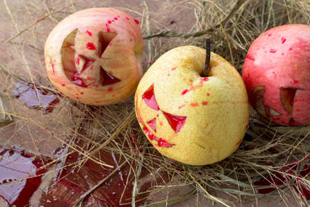 Chinese pear and apple for halloween on hayの写真素材