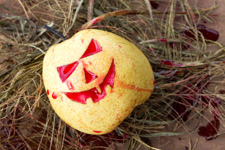 Chinese pear for halloween on hayの写真素材