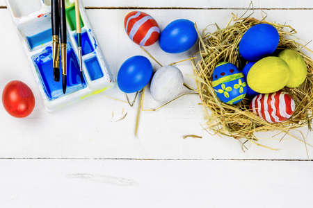 Easter background with Easter eggs and spring flowers. Top view with copy spaceの写真素材