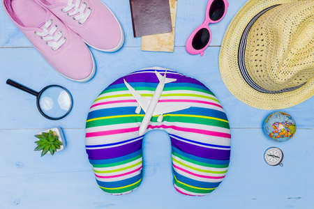 Top view essential travel items. map, passport, airplane, blue wooden background.Free space for creative design text and word.Flat lay different object for mock up.の写真素材