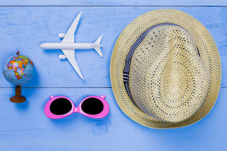Top view essential travel items on blue wooden background.Free space for creative design text and word.の写真素材
