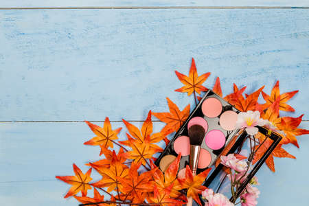 top view of professional decorative cosmetics, makeup tools on blue wooden backgroundの写真素材