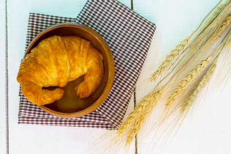 top view coffee and croissant with coffee bean. Rustic white wooden background with copy spaceの写真素材