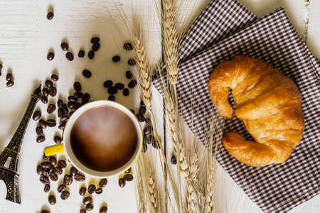 top view coffee and croissant with coffee bean. Rustic white wooden background with copy spaceの写真素材