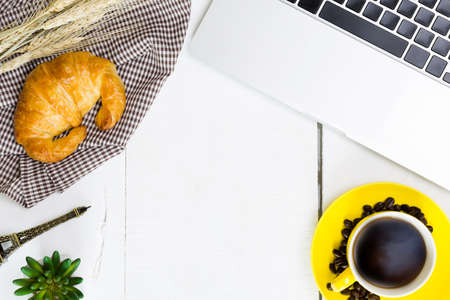 top view business breakfast with coffee and croussant. Rustic white wooden background with copy spaceの写真素材
