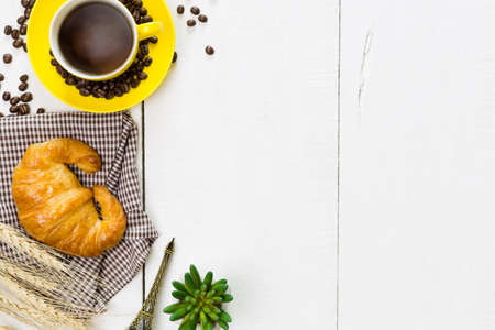 top view coffee and croissant with coffee bean. Rustic white wooden background with copy spaceの写真素材