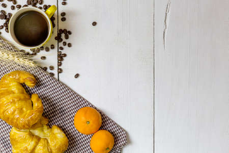 top view coffee and croissant with coffee bean. Rustic white wooden background with copy spaceの写真素材