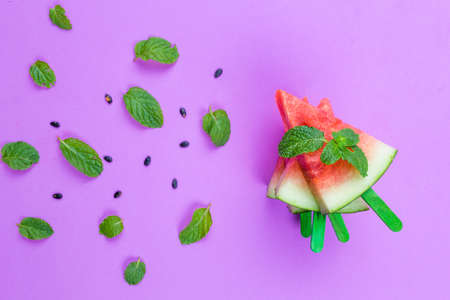 summer concept watermelon slice ice lolly on a pink backgroundの写真素材