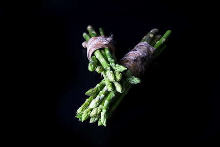Fresh green asparagus on black backgroundの写真素材